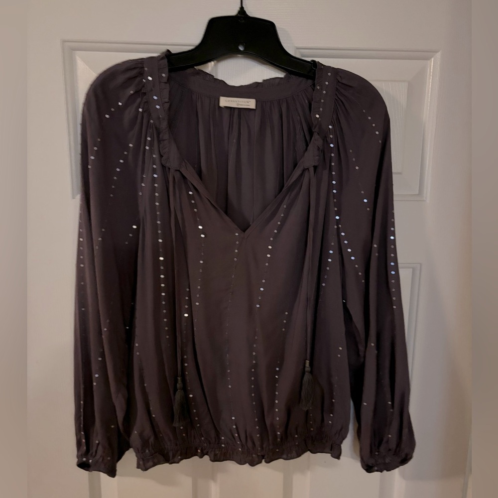 Deep purple feminine blouse with accent.